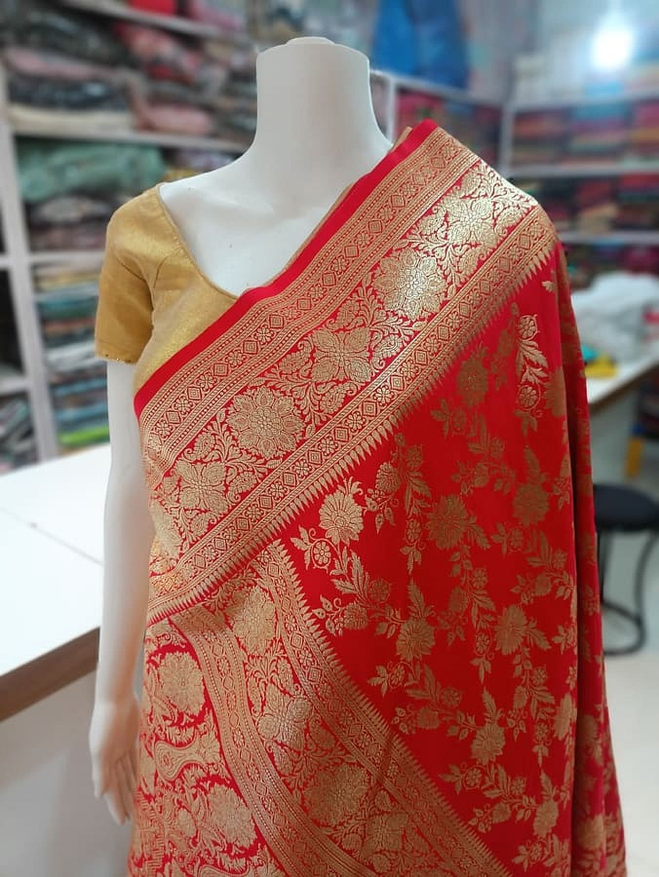Red Katan silk saree featuring gold-toned pallu border with vine motifs