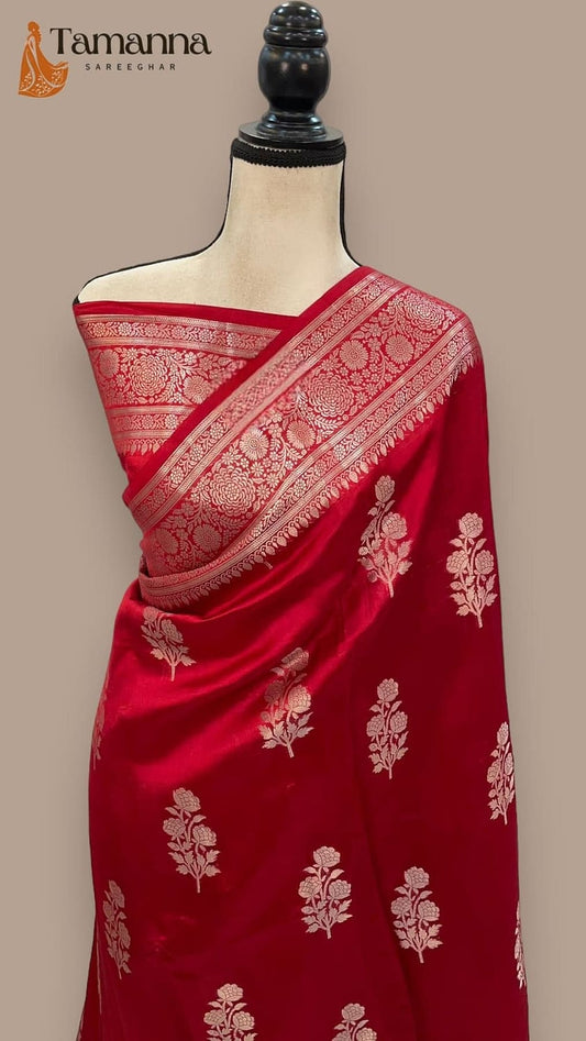 Red Banarasi silk saree with gold trim and floral motifs on pallu