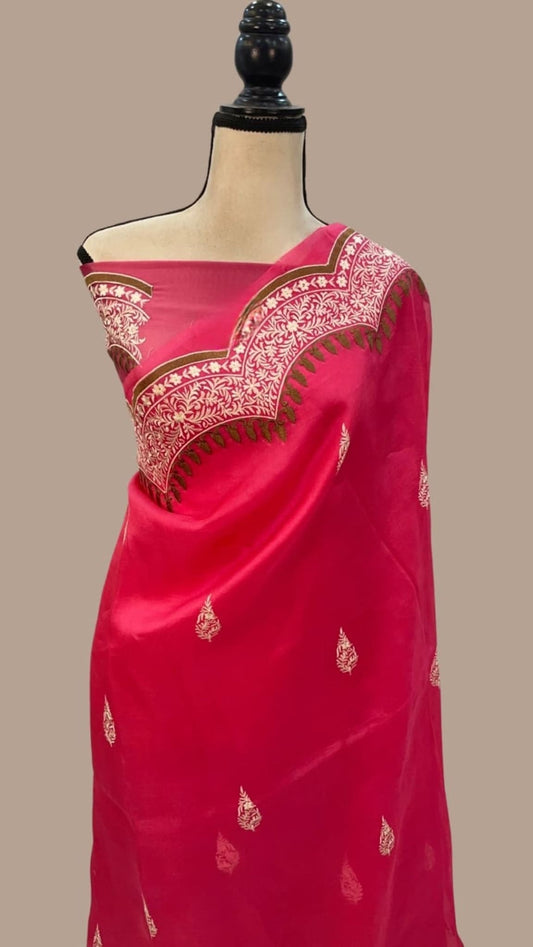 Red organza saree on mannequin, wide embroidered border across the shoulder pallu