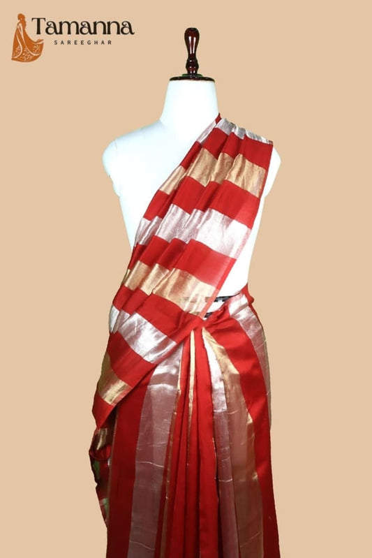 Red striped saree with gold and silver border on mannequin, tied pallu pleats