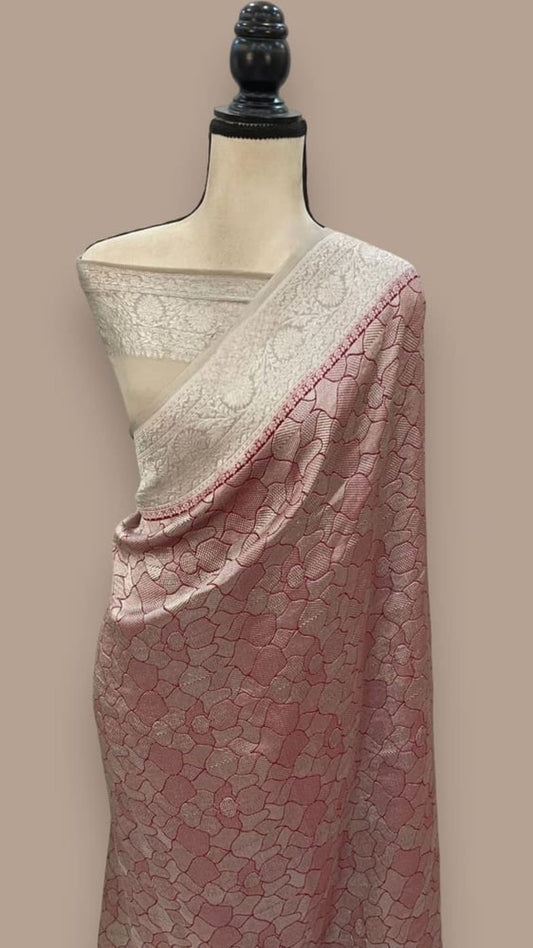 Red and white Banarasi saree with ornate border and woven floral pattern on draped body
