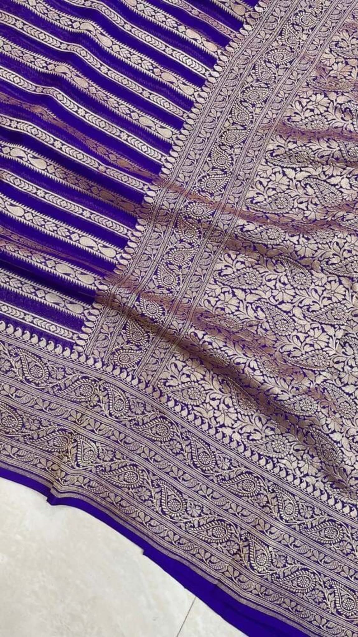 Royal blue Banarasi sari close-up: antique zari border with repeating oval and floral work