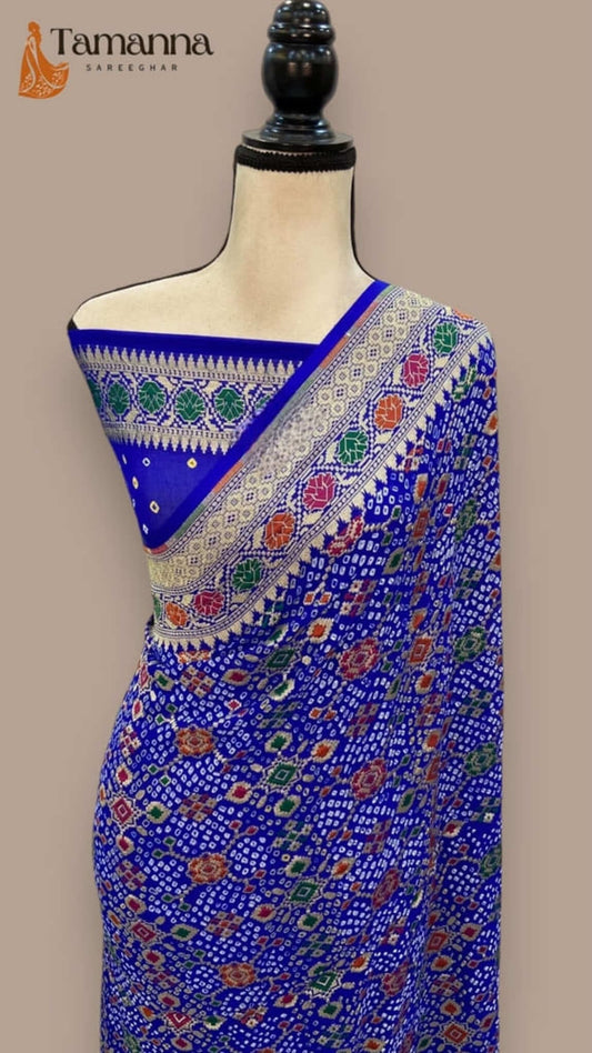 Royal blue Banarasi bandhej saree draped on mannequin with multicolor contrast border