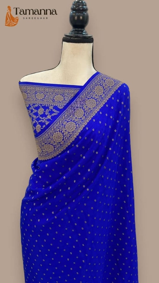 Royal blue saree with gold zari pallu and small dot motifs, drape on mannequin