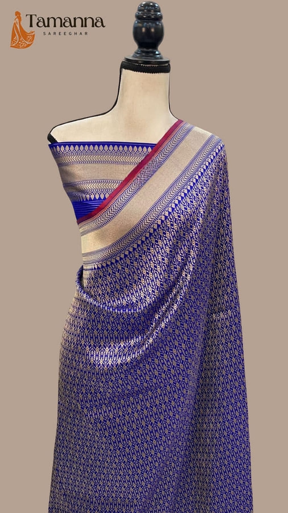 Royal blue Banarasi silk saree draped with gold border and maroon-red pallu detailing
