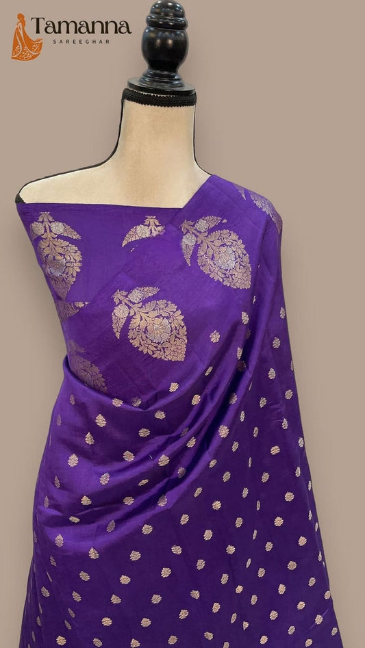 Purple mango silk saree draped on mannequin, gold zari floral motifs