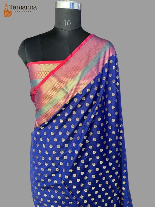 Royal blue pure silk Banarasi saree draped on mannequin, gold motifs with pink-green border