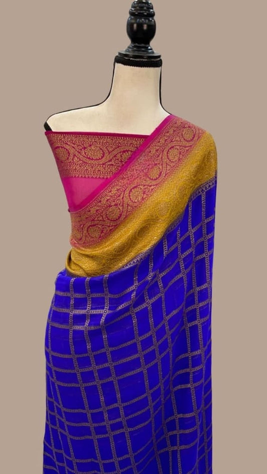 Royal blue saree draped on mannequin with grid pattern, yellow border, magenta pallu and zari