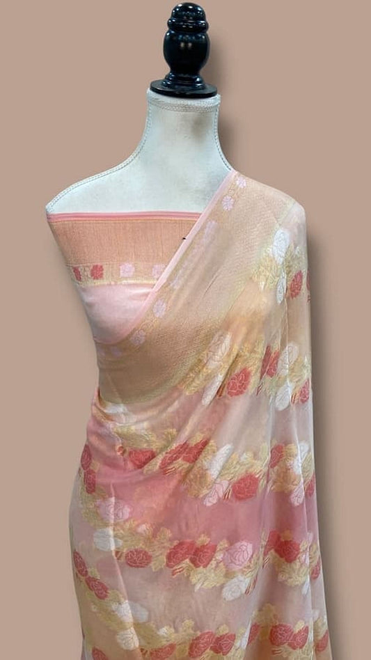 Light pink saree on mannequin with floral sprigs and thin contrasting border