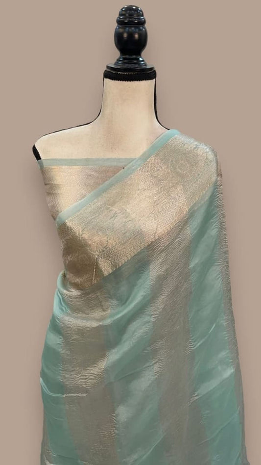 Handloom Banarasi saree on mannequin, teal body with beige/gold tissue border