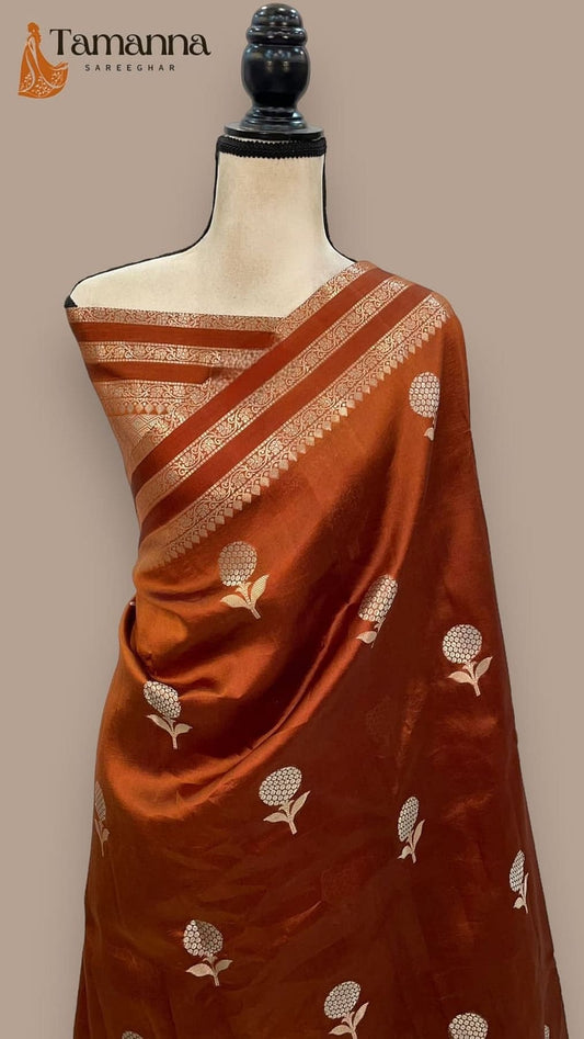 Rust-brown silk saree featuring gold diagonal stripes and small allover woven motifs on drape