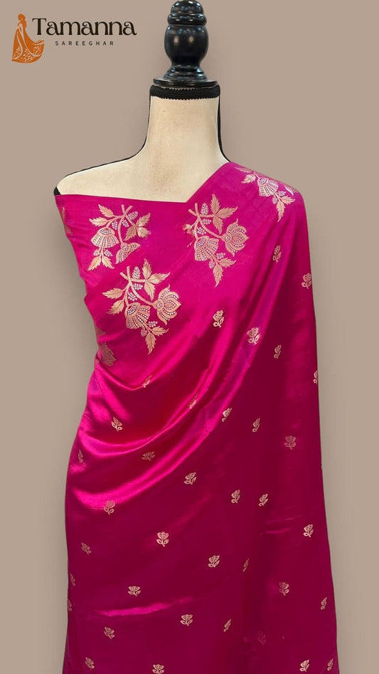 Magenta silk saree with gold-toned woven floral motifs across the body
