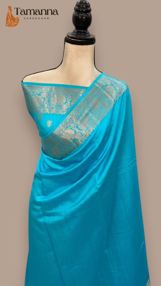 Sky blue silk sari with patterned teal-gold pallu and border