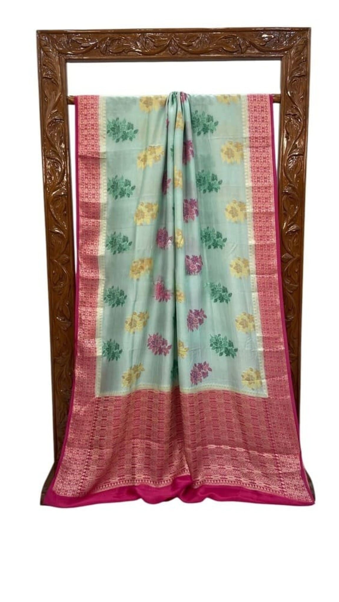 Sky blue Banarasi saree laid out with pink border strip and multicolor floral prints