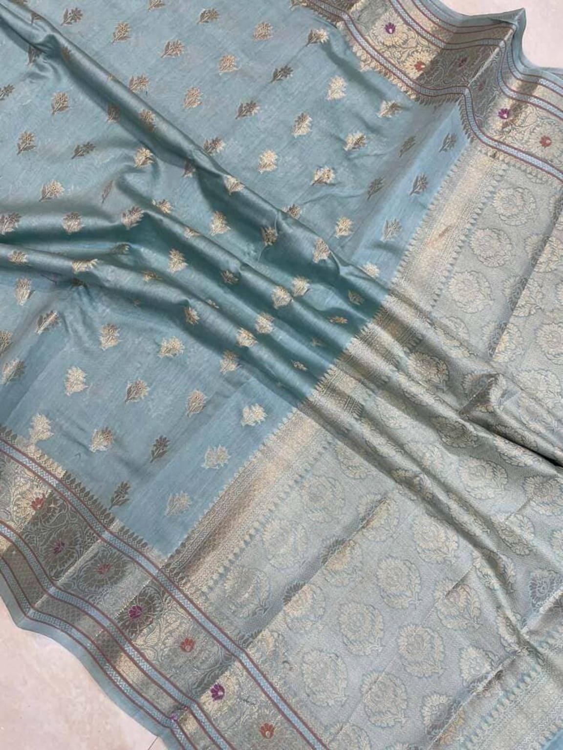 Sky blue cotton saree close-up of gold motifs and silver border with purple accents