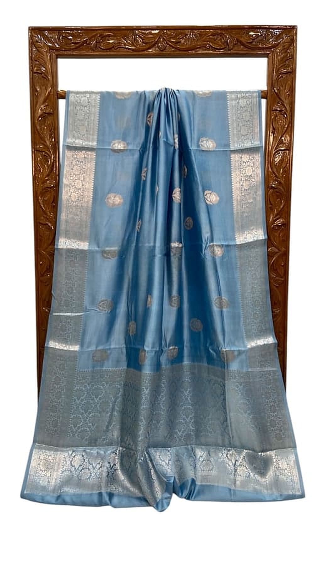 Sky blue silk saree with zari border and patterned panel, pleated and shown folded