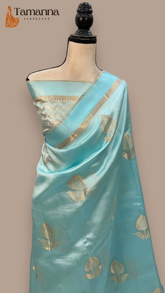 Light blue silk saree with gold leaf motifs and gold-trimmed pallu, front view