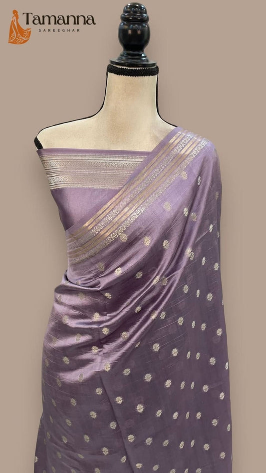 Lavender silk saree draped on mannequin, gold border, and dot motif pattern