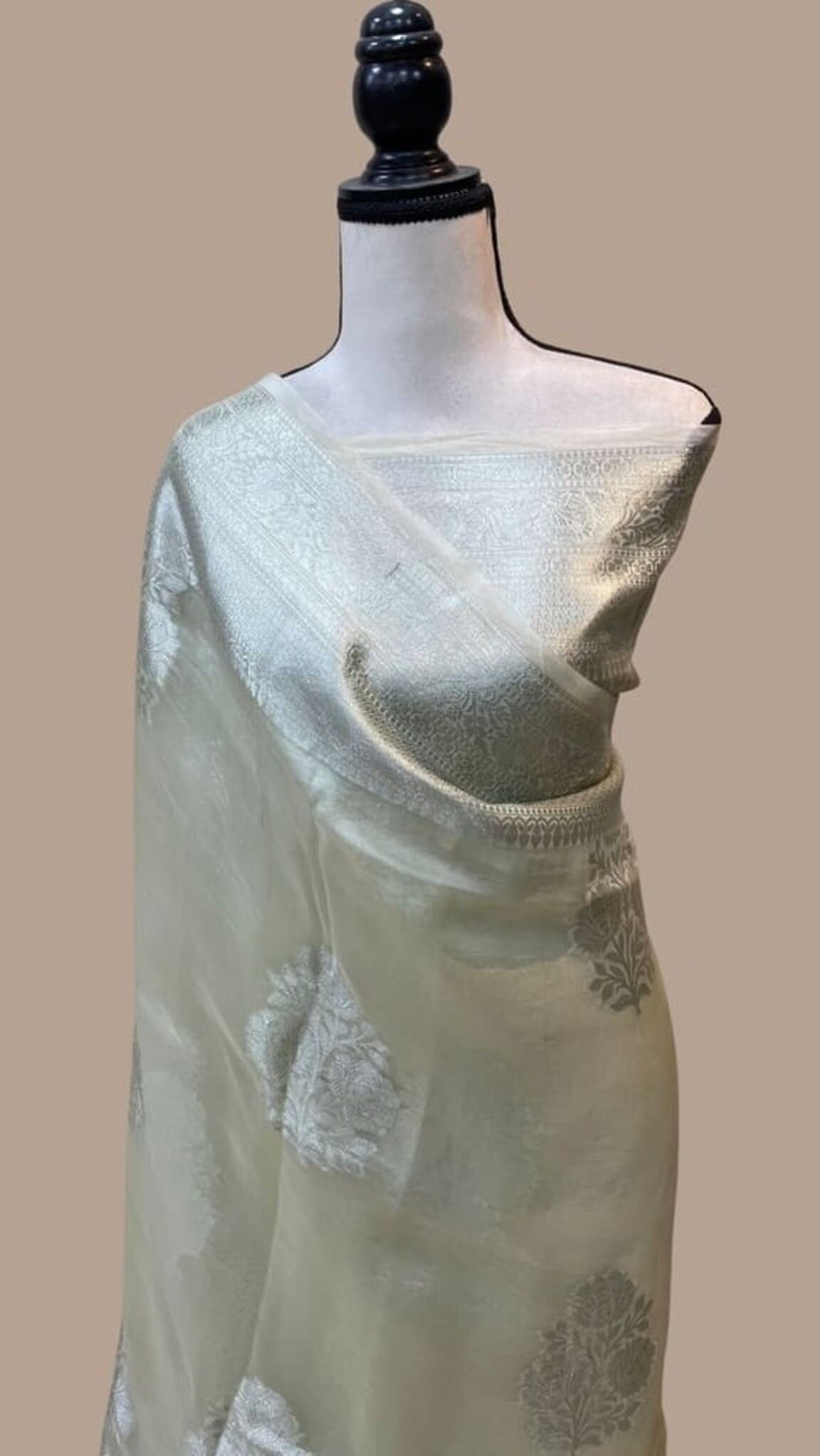 Smoky white handloom Banarasi saree with gold border and scattered floral motifs