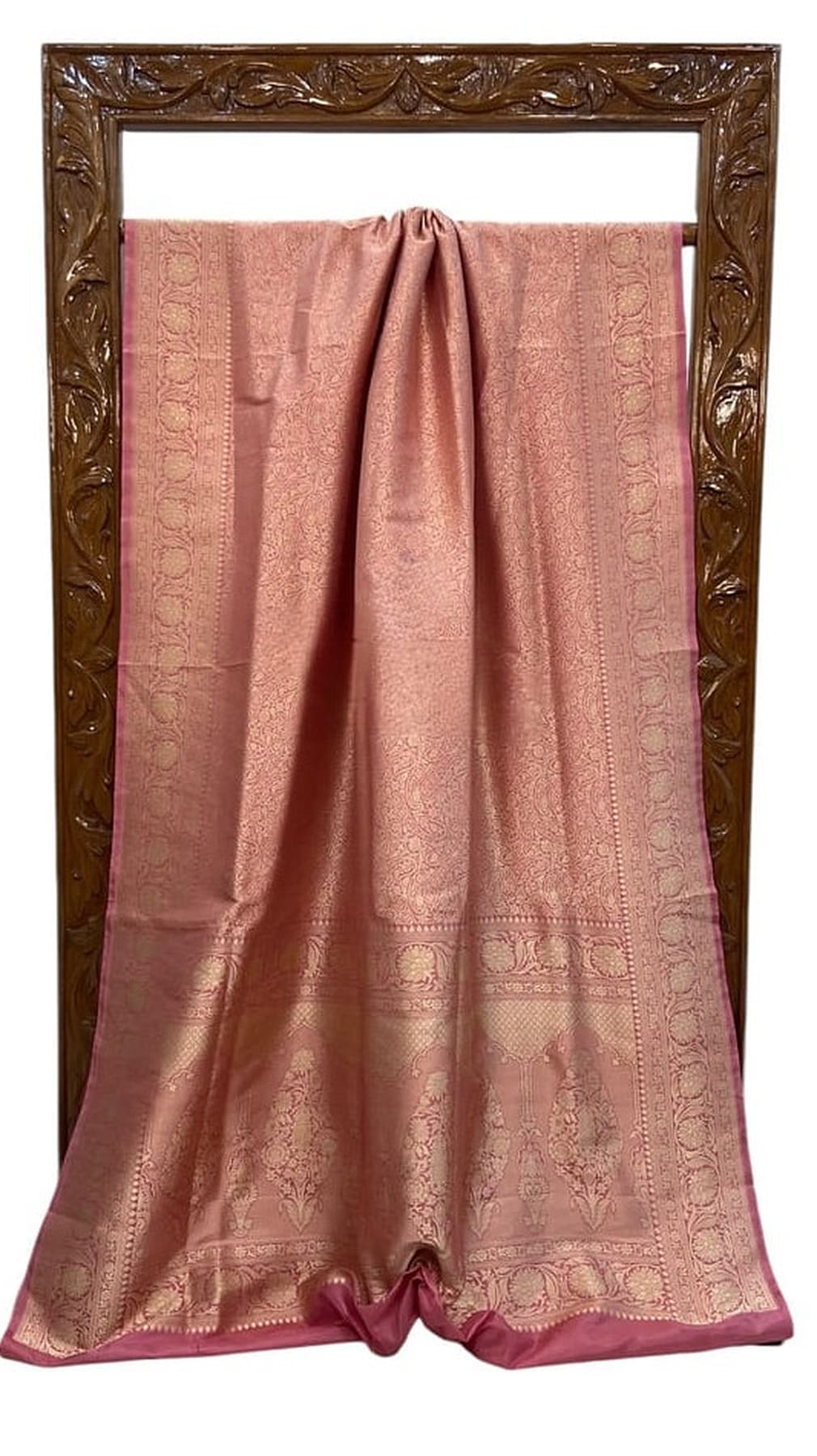 Soft pink silk saree laid flat with jacquard brocade border and woven designs