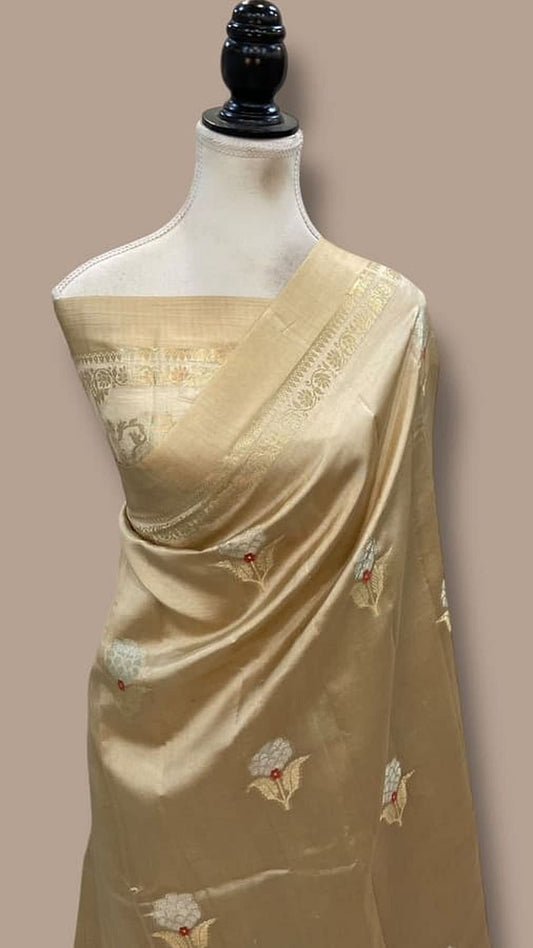 Gold-beige Banarasi handloom saree draped on mannequin with bird motifs and zari border