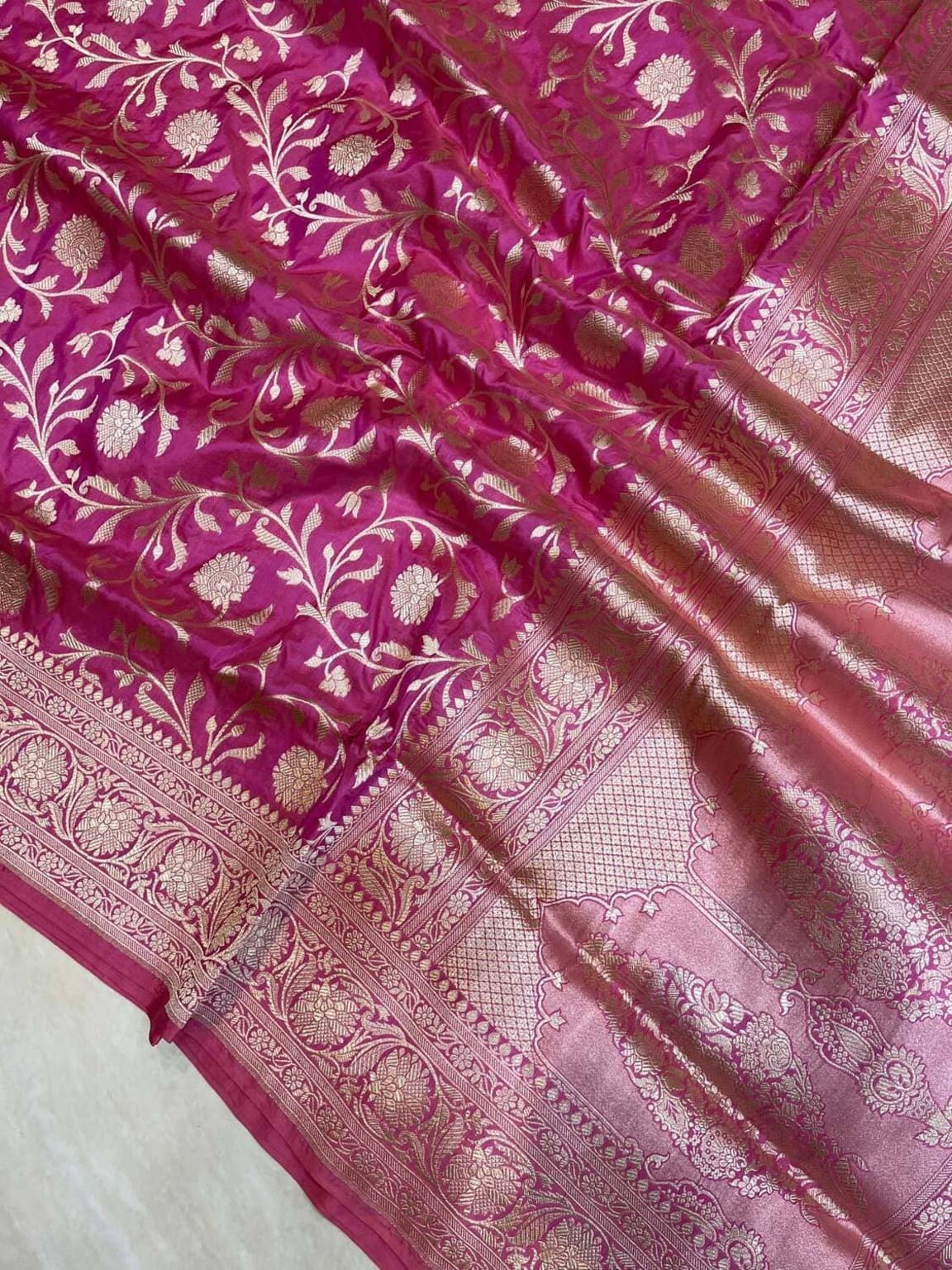 Banarasi silk border detail, magenta fabric with gold zari vines and pink panel