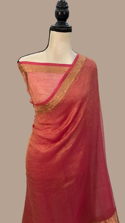 Pink and gold saree draped on mannequin, gold border along the pallu and edge