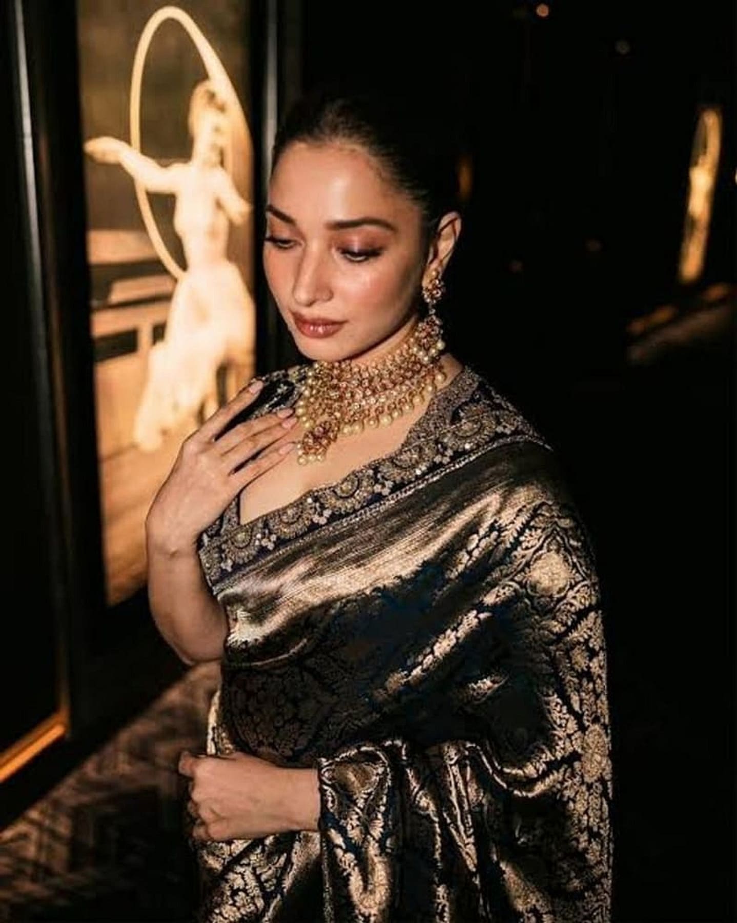 Navy blue silk saree detail with gold zari motifs and textured brocade sheen