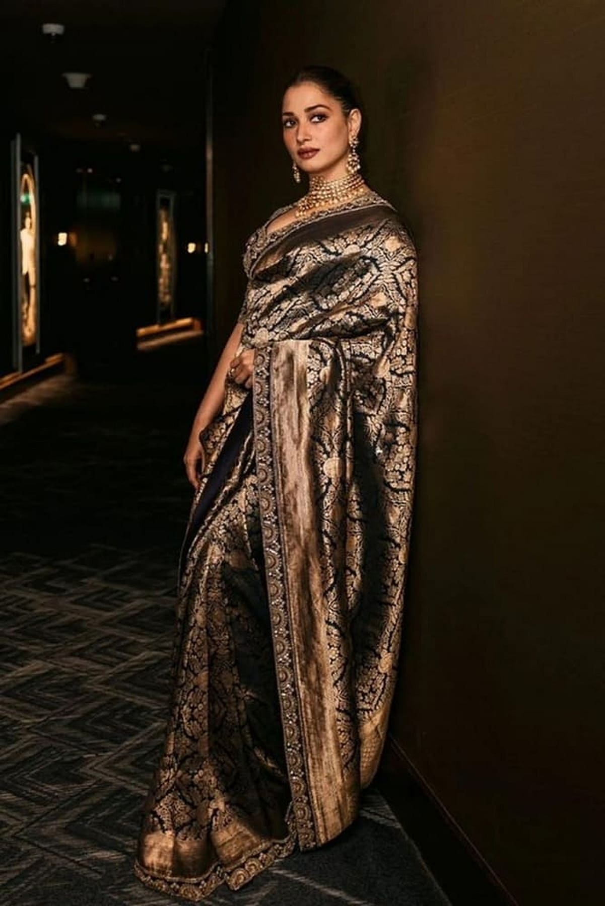 Navy blue silk saree with bold brocade pattern and ornate wide border hem