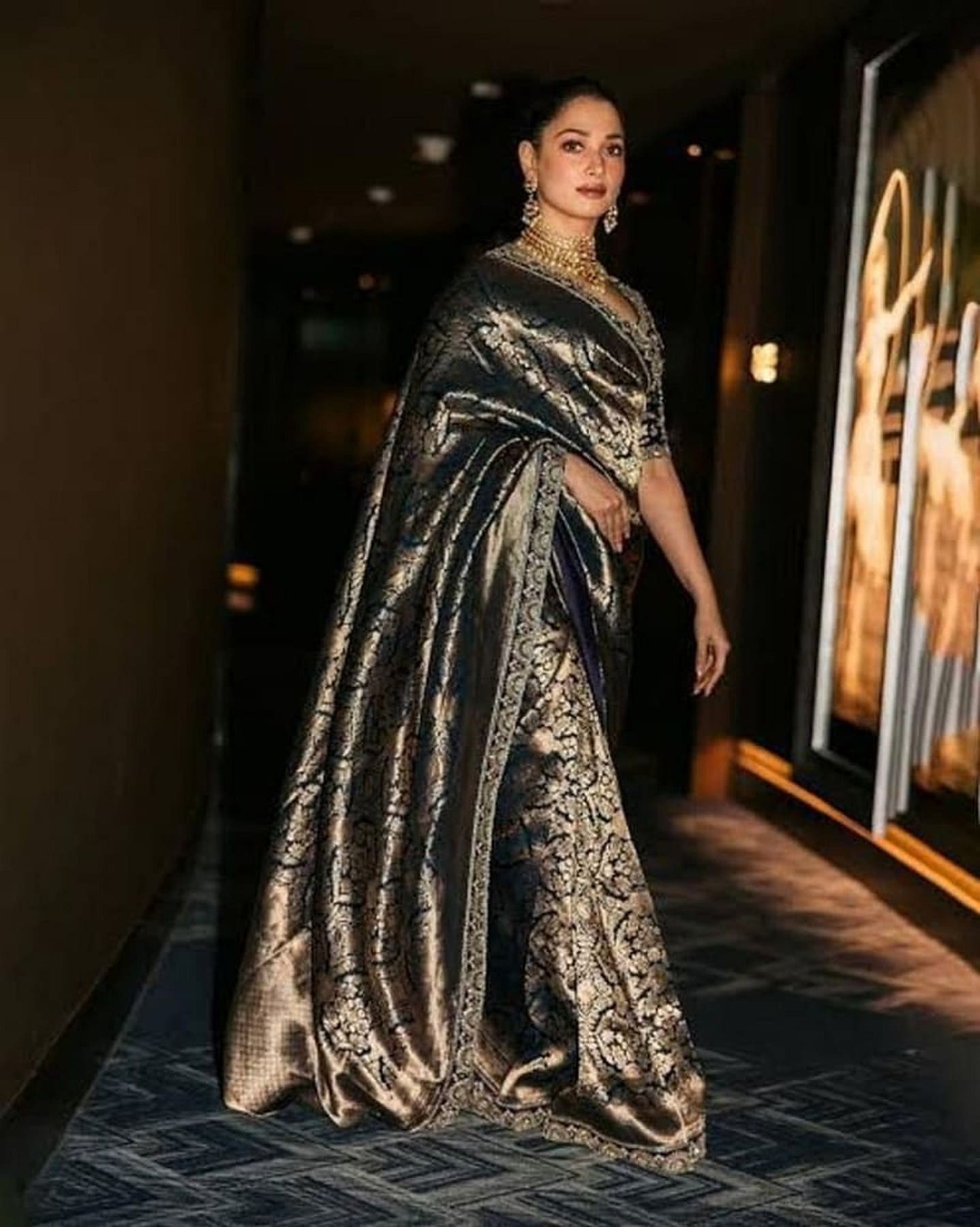 Metallic navy blue silk saree with silver-gold zari motifs and draped pallu