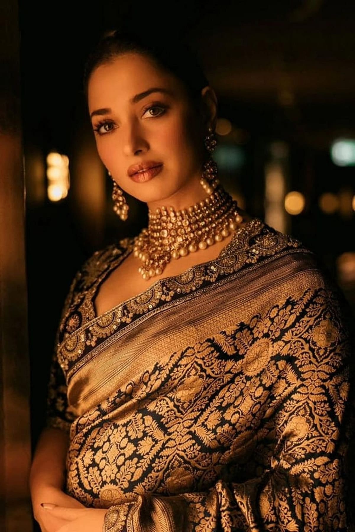 Navy blue silk saree with intricate gold zari work and patterned pallu border