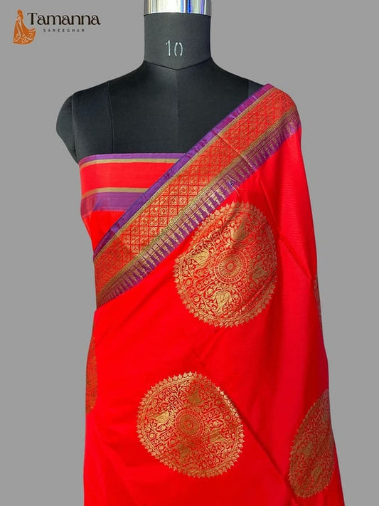 Red silk saree with ornate gold medallion motifs and multicolor border