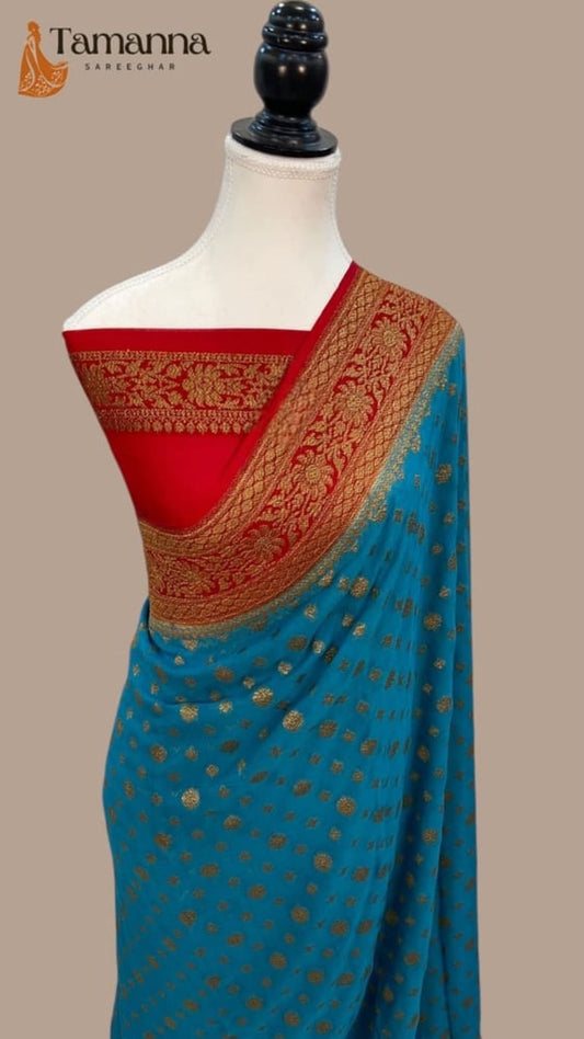 Turquoise saree drape with red band, gold zari pallu border, tiny motifs