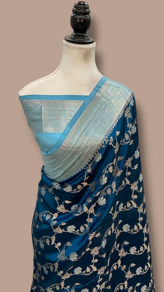 Draped navy silk saree with light blue pallu and gold zari floral pattern