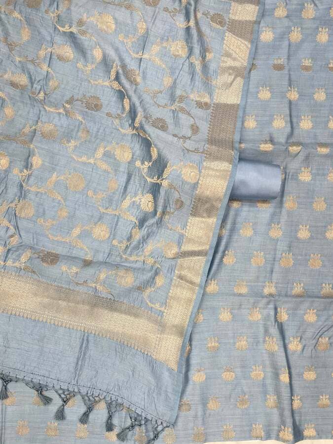 Turquoise blue silk fabric with gold dot motifs, contrasting panel, and zari edging