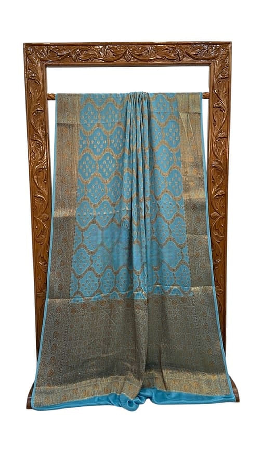 Turquoise blue saree with gold woven patterns, matching border and draped pallu on display