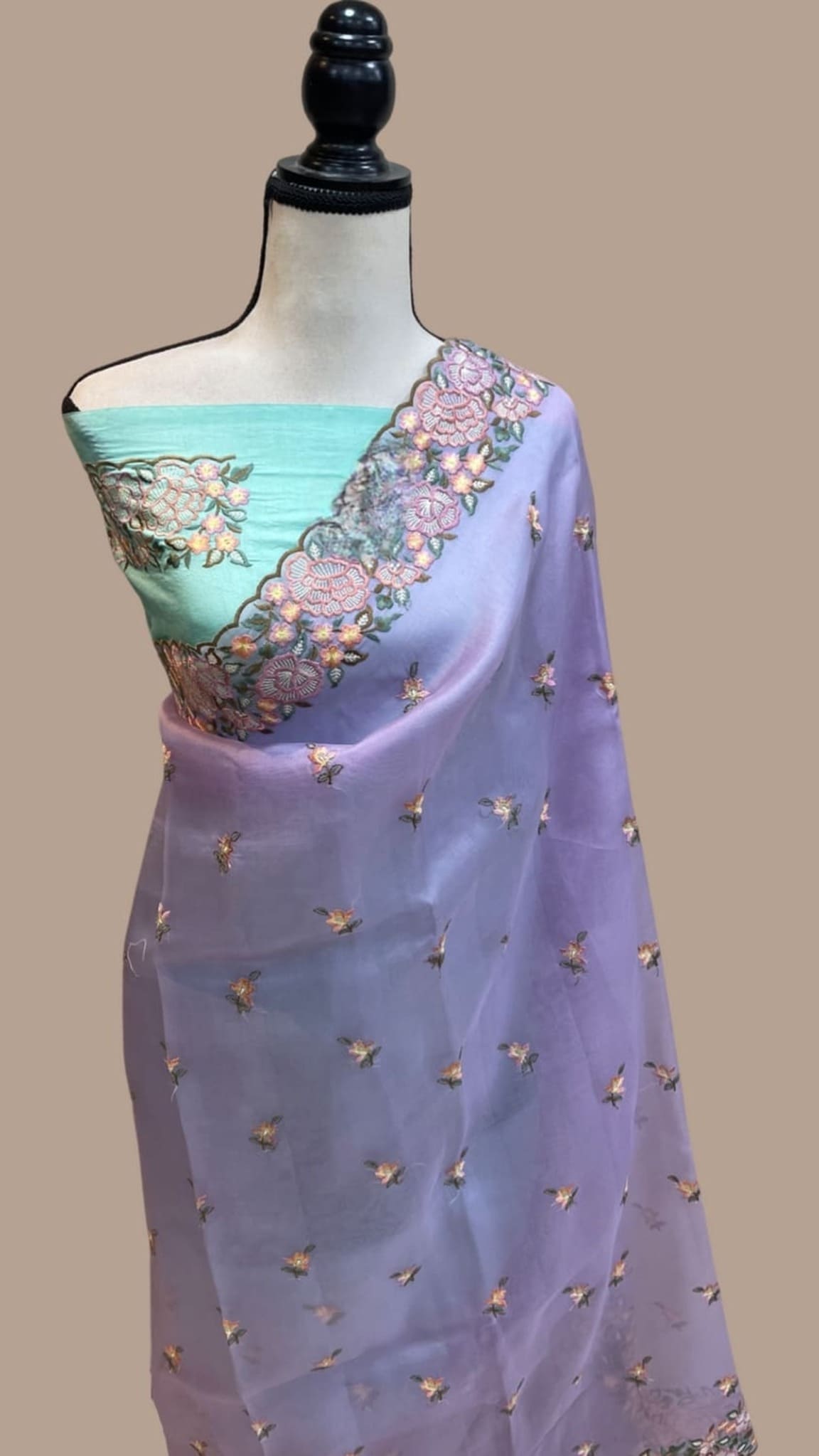 Lilac organza saree with turquoise blouse panel, gold sprigs, and floral pallu border