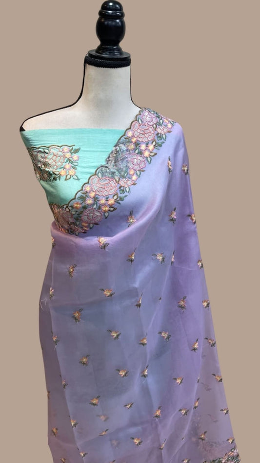 Lilac organza saree with turquoise blouse panel, gold sprigs, and floral pallu border