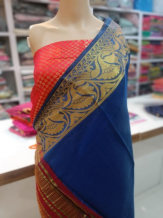 Dark blue silk saree with ornate gold border, red contrast panel
