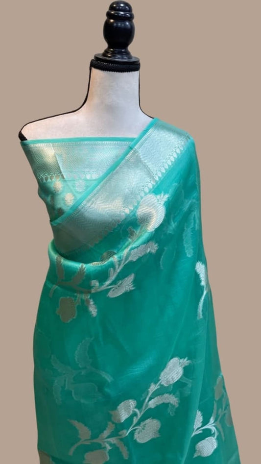 Turquoise Banarasi kora handloom saree with silver floral motifs and contrast border