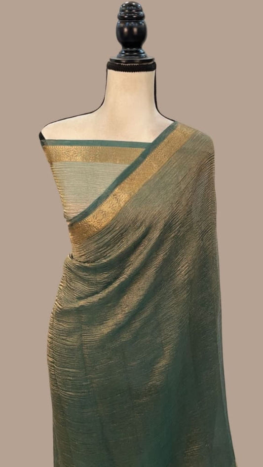 Teal-green tissue Banarasi saree with gold zari border and diagonal pallu drape