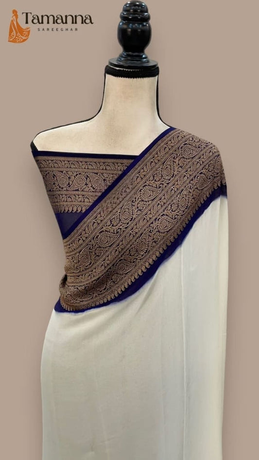 Off-white saree with navy blue diagonal banarasi border and ornate brown-gold pallu