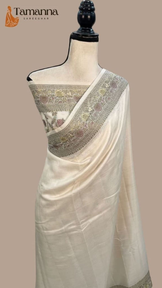 Off-white Banarasi crepe saree on mannequin, grey-gold zari pallu border