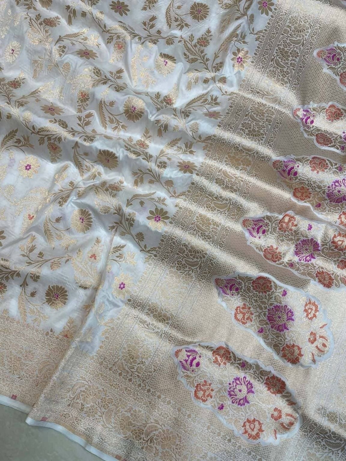 Ivory silk saree with striped jaal lines and pastel meenakari floral motifs