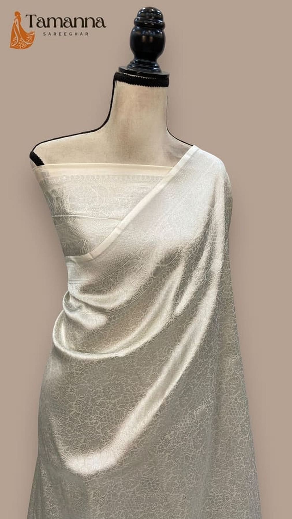 White Banarasi silk saree, diagonal pallu fall with delicate motifs and woven trim