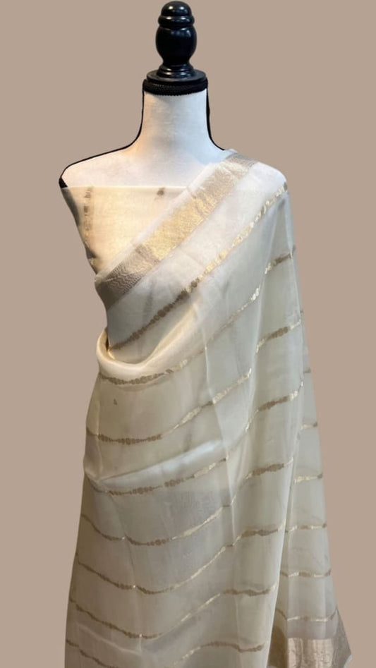White handloom Banarasi saree with gold-toned striped border and woven texture