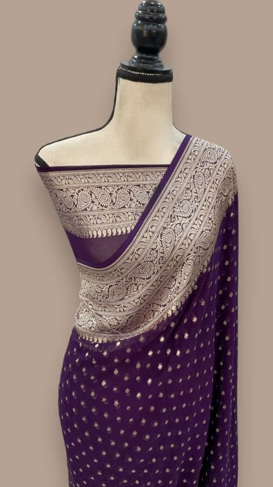 Wine purple saree with zari-embroidered border and scattered gold dots, draped