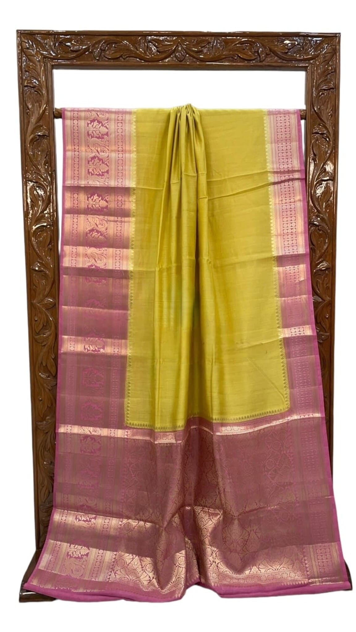 Yellow and pink silk saree with checkered border panels and gold trim, folded