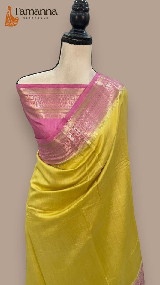 Yellow silk saree with pink pallu featuring gold woven accents