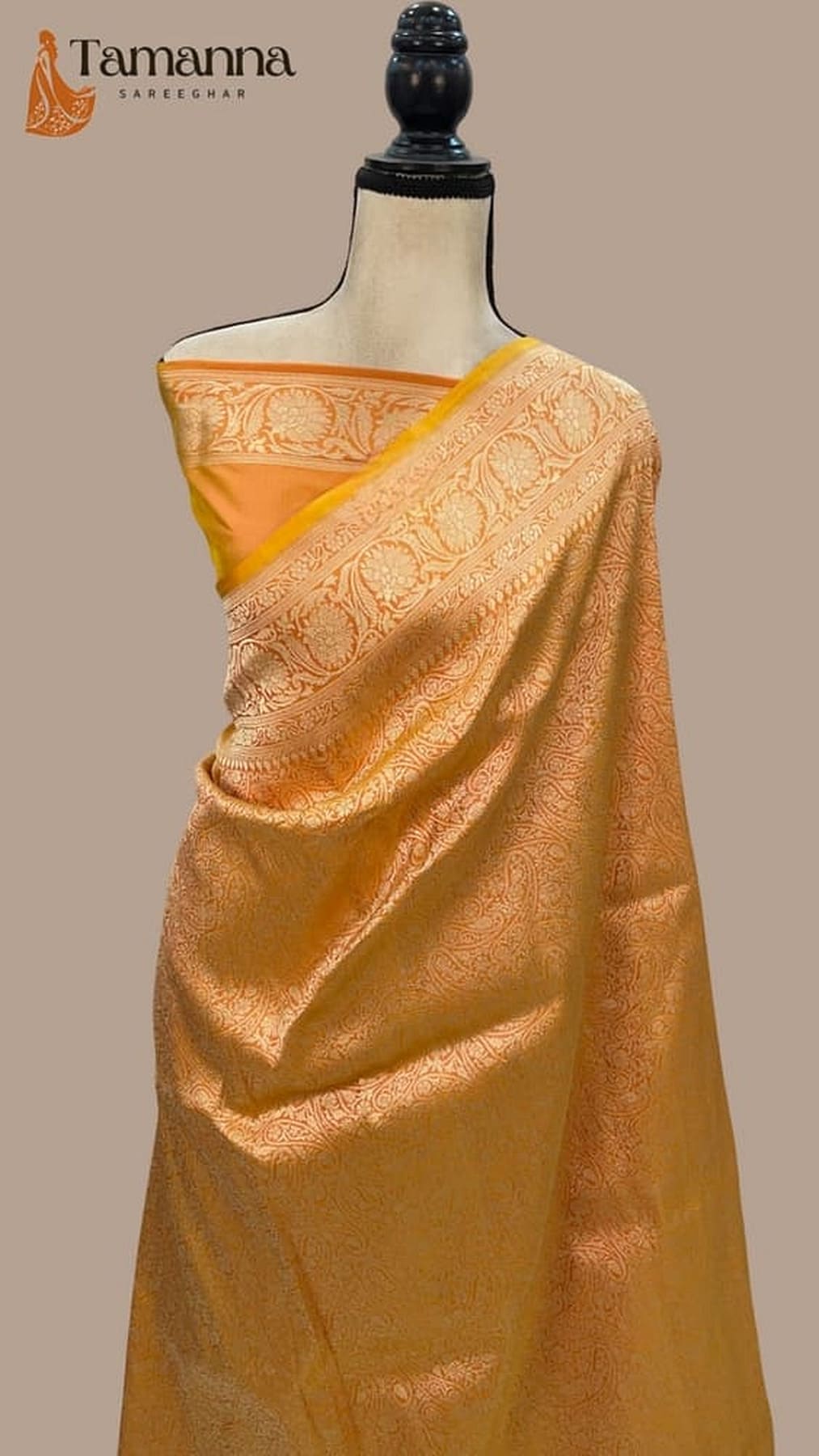 Yellow-gold Banarasi silk saree with ornate woven pallu and contrasting edge